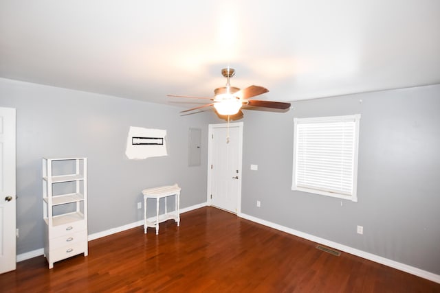 spare room with dark wood-type flooring, electric panel, and ceiling fan