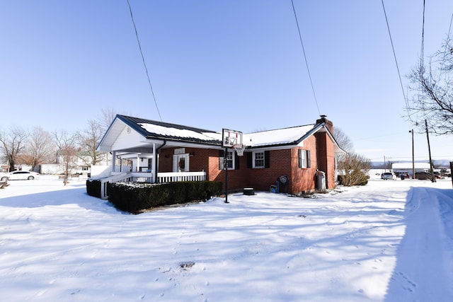 snow covered house with covered porch