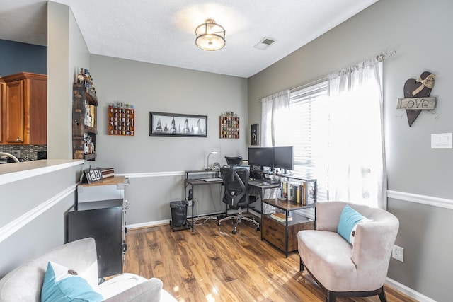 office space with hardwood / wood-style flooring and a textured ceiling