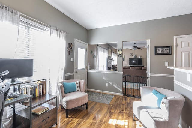 sitting room with hardwood / wood-style floors, a textured ceiling, and ceiling fan