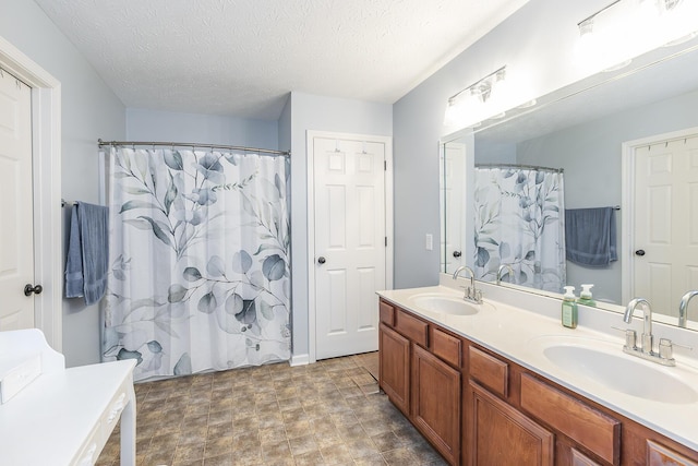 bathroom featuring vanity, walk in shower, and a textured ceiling