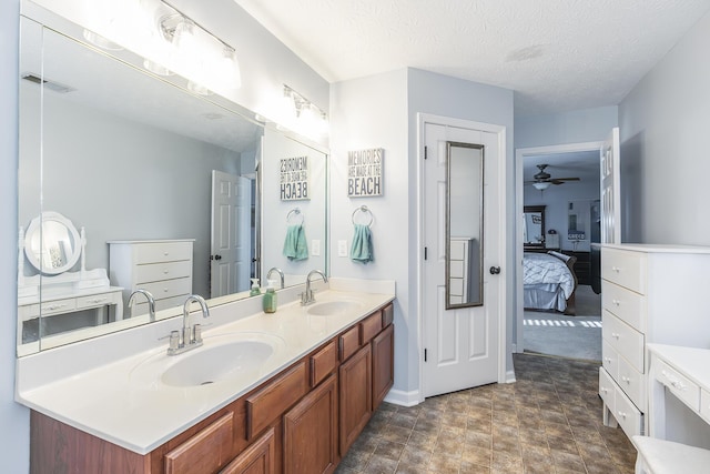 bathroom featuring a textured ceiling, ceiling fan, and vanity