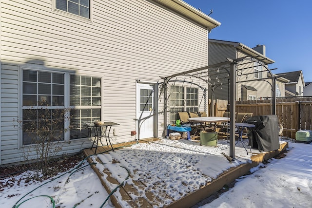 snow covered patio with a pergola