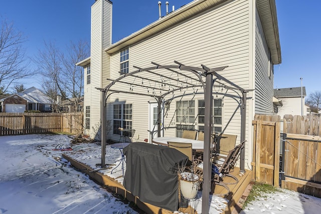 snow covered house with a pergola