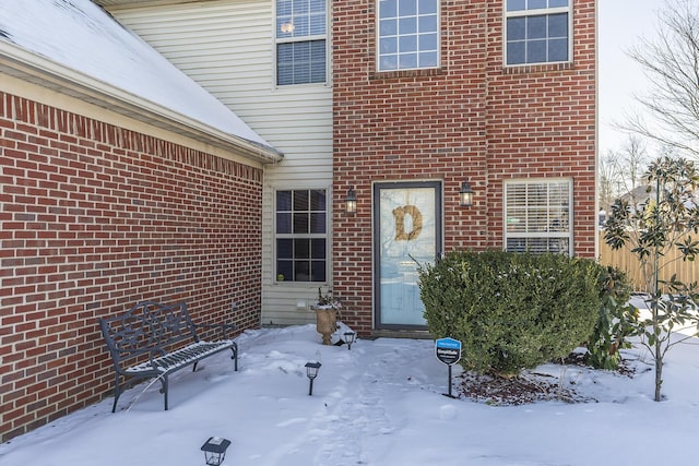 view of snow covered property entrance