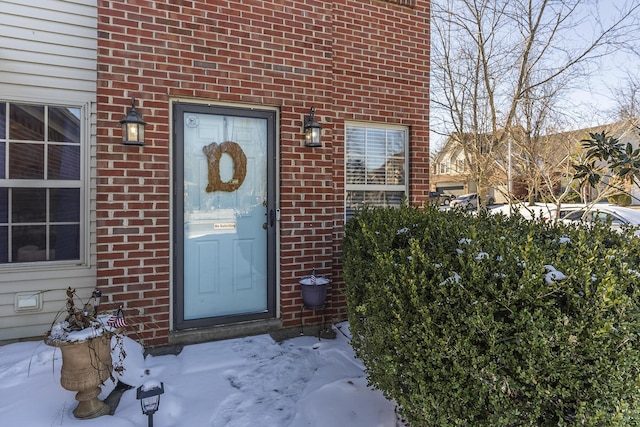 view of snow covered property entrance