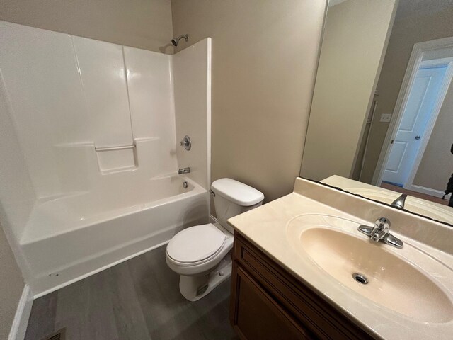 bathroom featuring shower / bath combination, hardwood / wood-style floors, and toilet