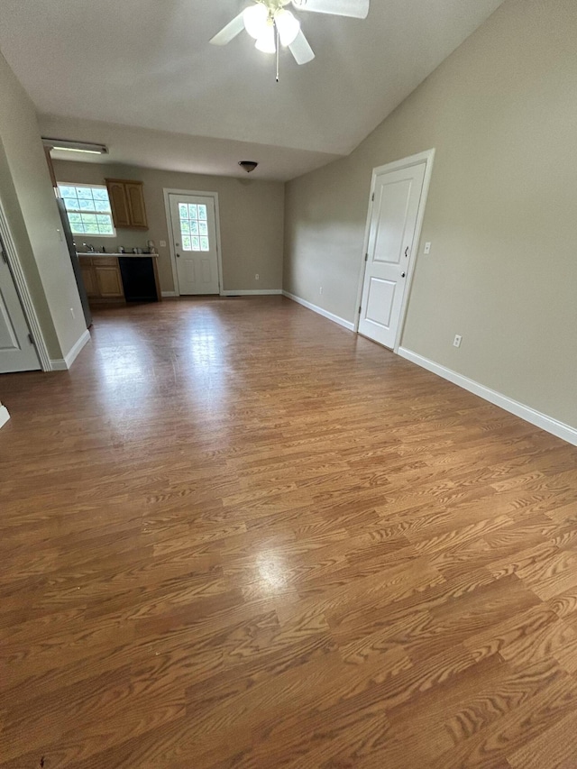 1465 Blaze Valley Rd, Somerset, KY 42501 - unfurnished living room featuring a ceiling fan, dark wood finished floors, baseboards, and vaulted ceiling