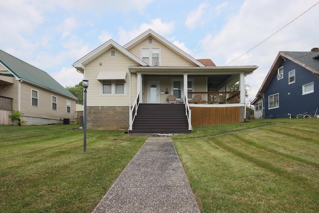 bungalow with a front yard and a porch