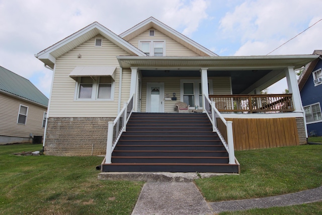 view of front of house with a porch and a front lawn