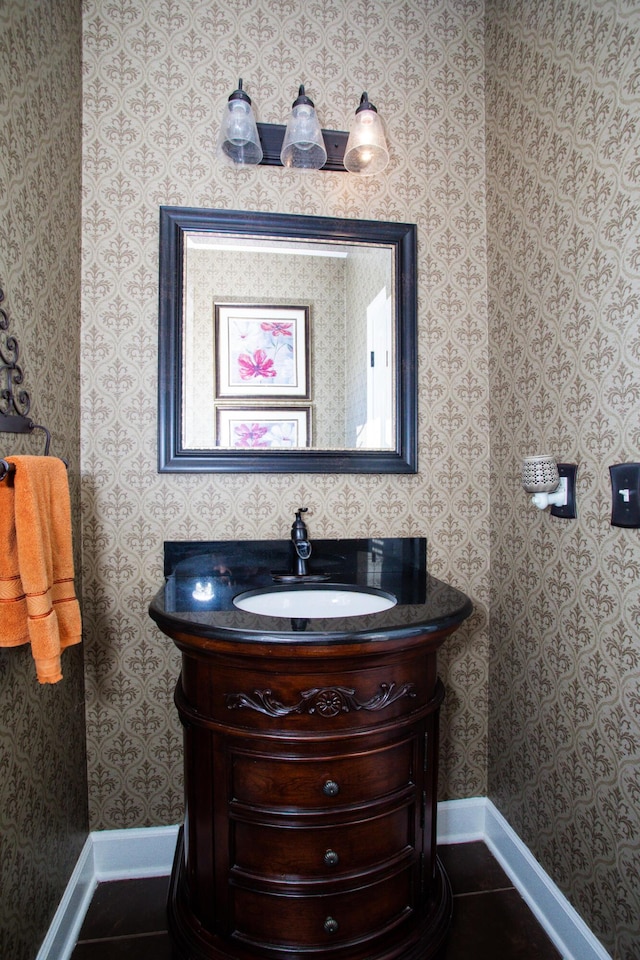 bathroom featuring tile patterned flooring, baseboards, and wallpapered walls