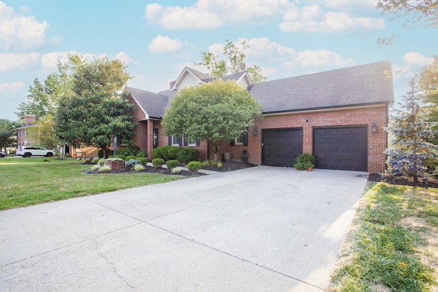 view of front of property featuring concrete driveway, roof with shingles, an attached garage, a front lawn, and brick siding