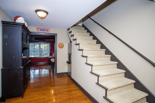 stairway with baseboards and wood finished floors