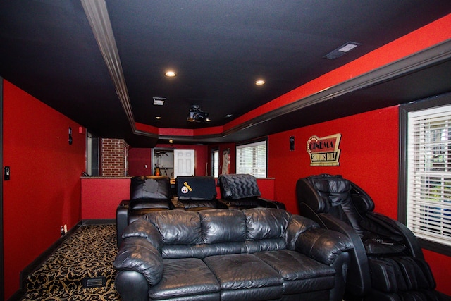 cinema featuring carpet floors, a tray ceiling, visible vents, and plenty of natural light