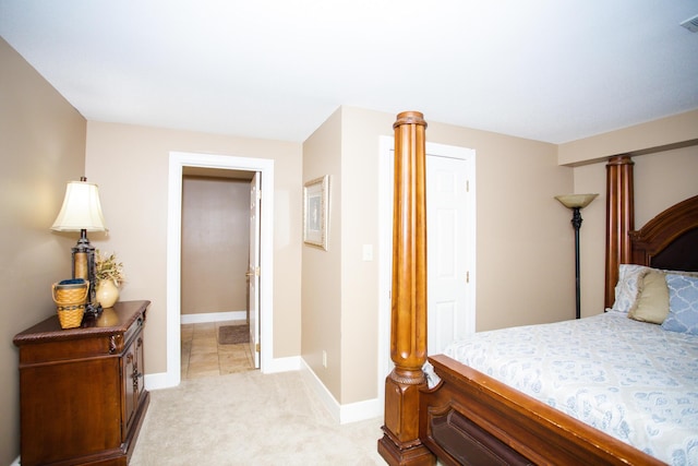 bedroom featuring baseboards, ornate columns, visible vents, and light colored carpet