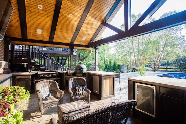 view of patio / terrace featuring stairs, wine cooler, and grilling area