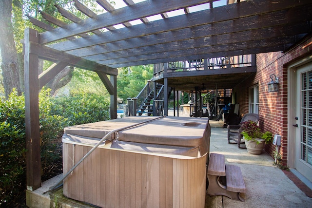 view of patio / terrace with stairway, a pergola, and a hot tub