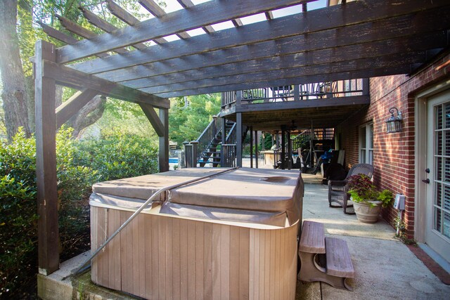 view of patio / terrace featuring a deck, a pergola, and a hot tub