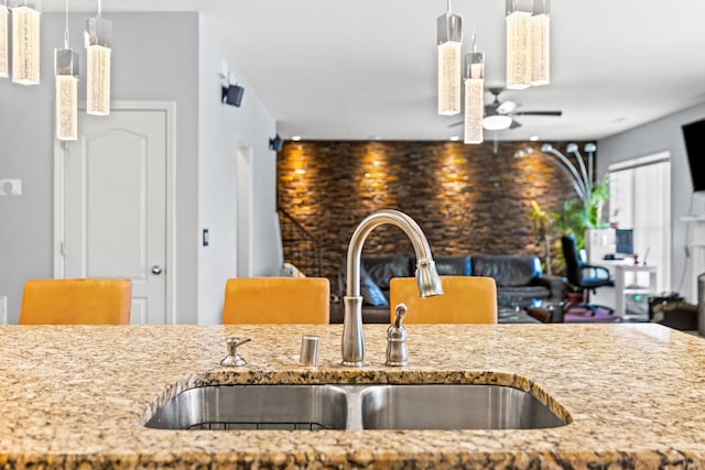 kitchen featuring sink, decorative light fixtures, and ceiling fan