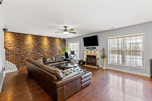 living room with dark wood-type flooring and ceiling fan