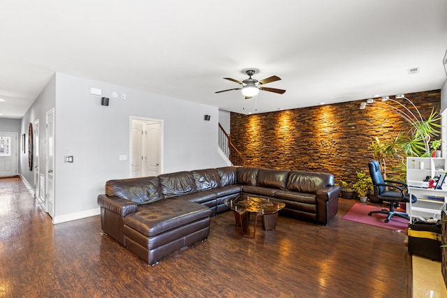 living room featuring ceiling fan and dark hardwood / wood-style flooring