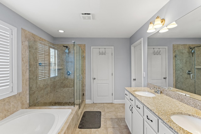 bathroom featuring vanity, tile patterned flooring, and shower with separate bathtub