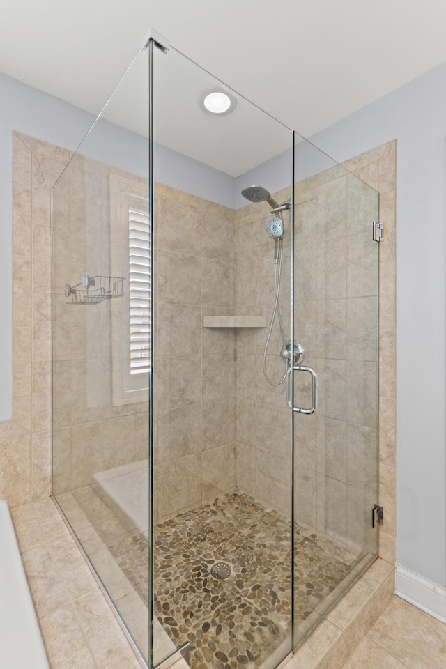 bathroom featuring tile patterned flooring and an enclosed shower