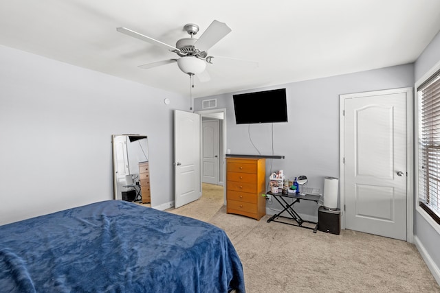 carpeted bedroom featuring ceiling fan and multiple windows