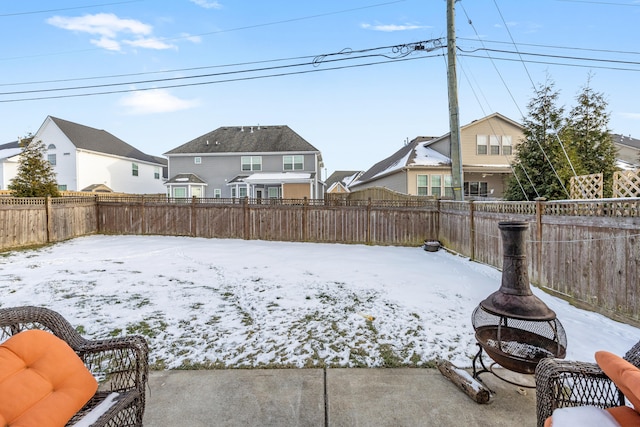 snowy yard featuring a fire pit