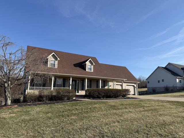 new england style home with an attached garage, driveway, a front lawn, and a porch