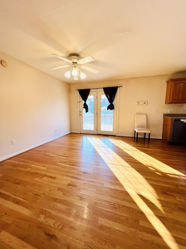 interior space featuring baseboards, light wood-style flooring, and a ceiling fan