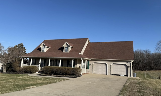 view of front of home featuring driveway, a garage, a porch, and a front yard