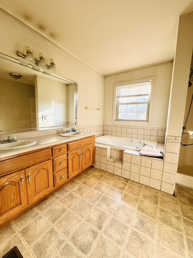 full bathroom with a bath, double vanity, and a sink