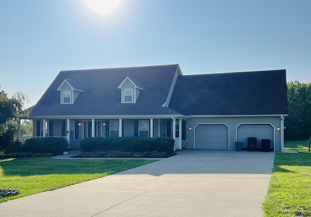 view of front of home with a garage, concrete driveway, a porch, and a front yard