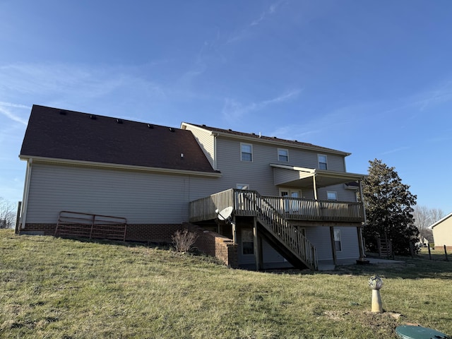 rear view of house featuring a yard, stairway, and a wooden deck