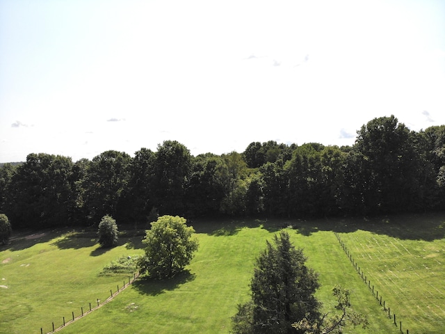 view of yard featuring fence and a rural view