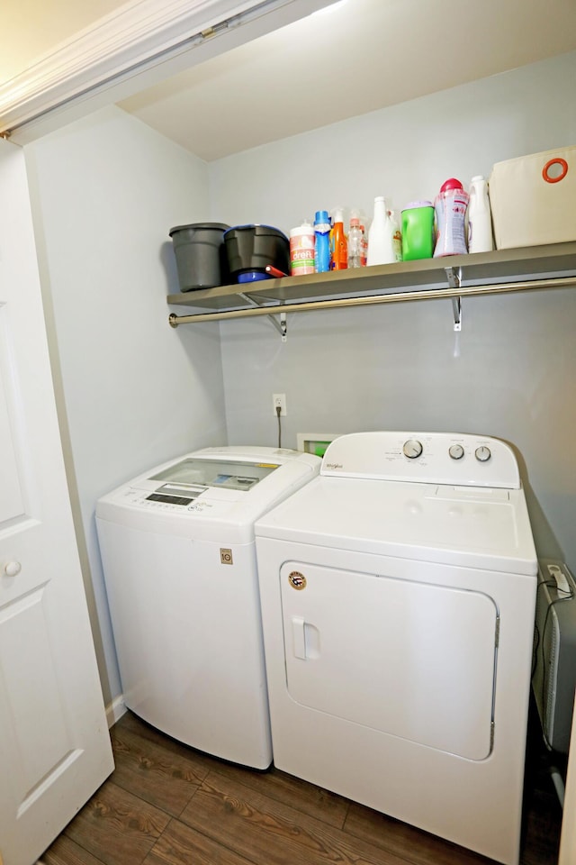 washroom with dark wood-type flooring and washer and clothes dryer