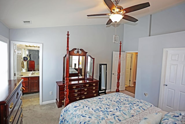 bedroom with sink, vaulted ceiling, and light colored carpet