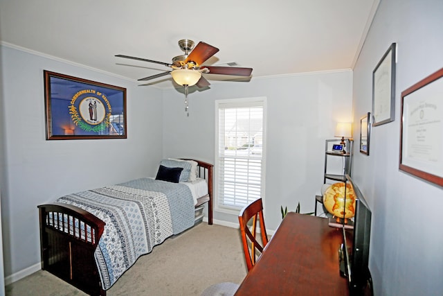 carpeted bedroom with ceiling fan and ornamental molding