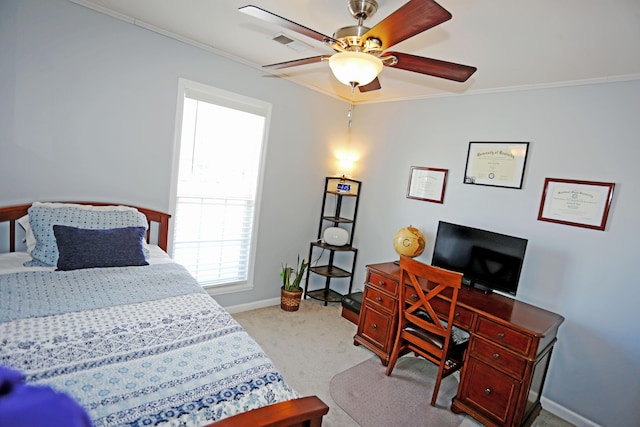 carpeted bedroom featuring crown molding and ceiling fan