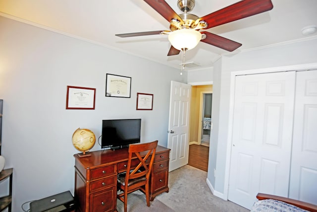 office area featuring ceiling fan, light colored carpet, and ornamental molding