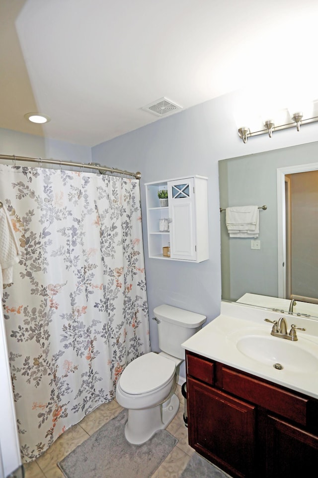 bathroom featuring tile patterned floors, vanity, and toilet