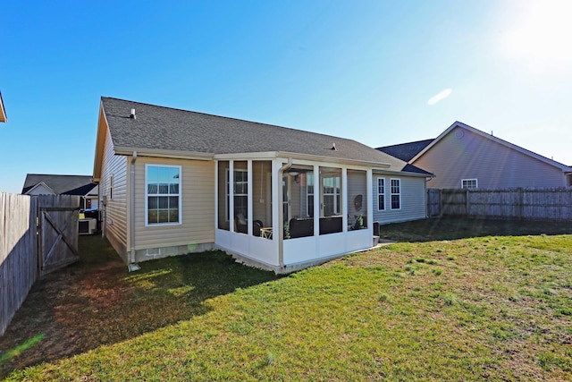 back of property featuring a sunroom, a yard, and central AC