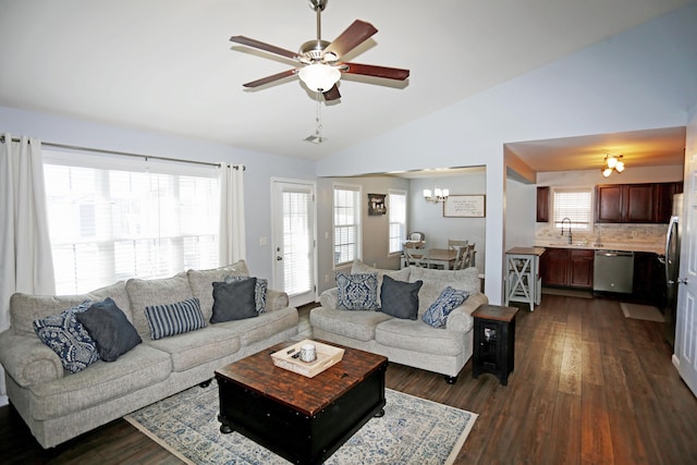 living room with dark wood-type flooring, ceiling fan with notable chandelier, and vaulted ceiling