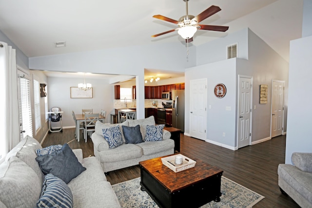 living room featuring sink, ceiling fan with notable chandelier, vaulted ceiling, and dark hardwood / wood-style floors