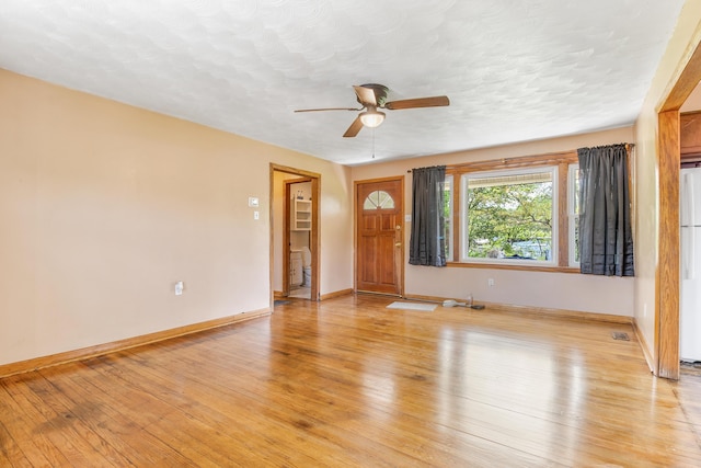 interior space featuring ceiling fan, a textured ceiling, and light wood-type flooring