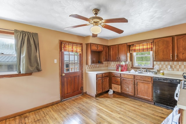 kitchen featuring sink, light hardwood / wood-style floors, dishwasher, and a wealth of natural light