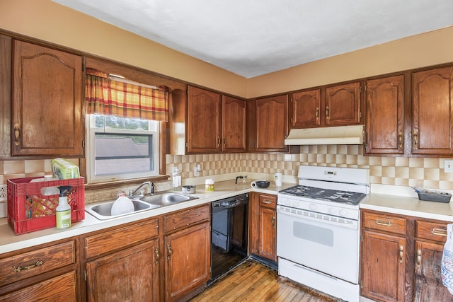 kitchen with dishwasher, decorative backsplash, sink, white gas stove, and light wood-type flooring