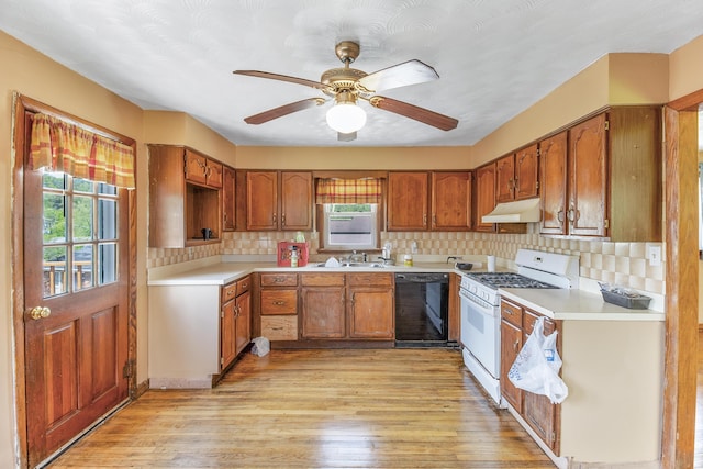 kitchen with white gas stove, black dishwasher, tasteful backsplash, light hardwood / wood-style flooring, and ceiling fan