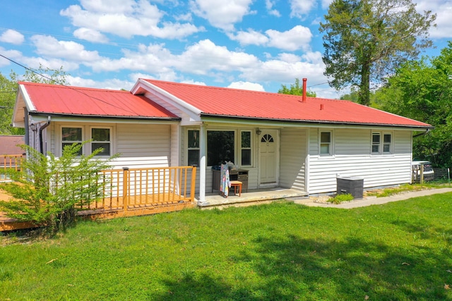 rear view of property with a yard